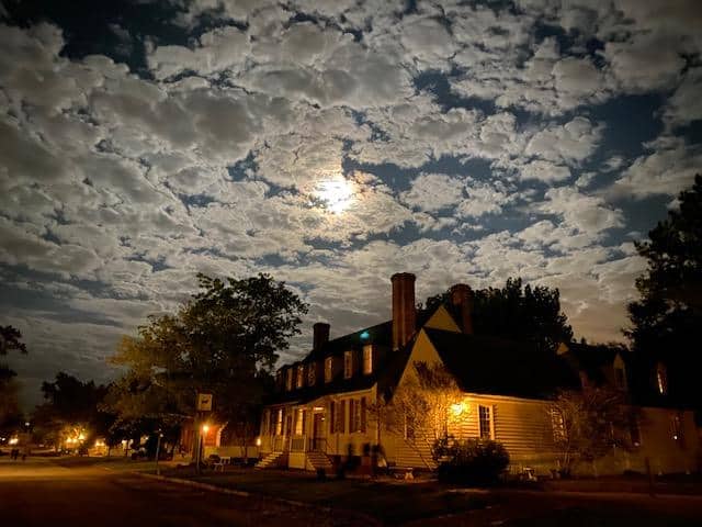 White house in Williamsburg on a cloudy night - haunted USA