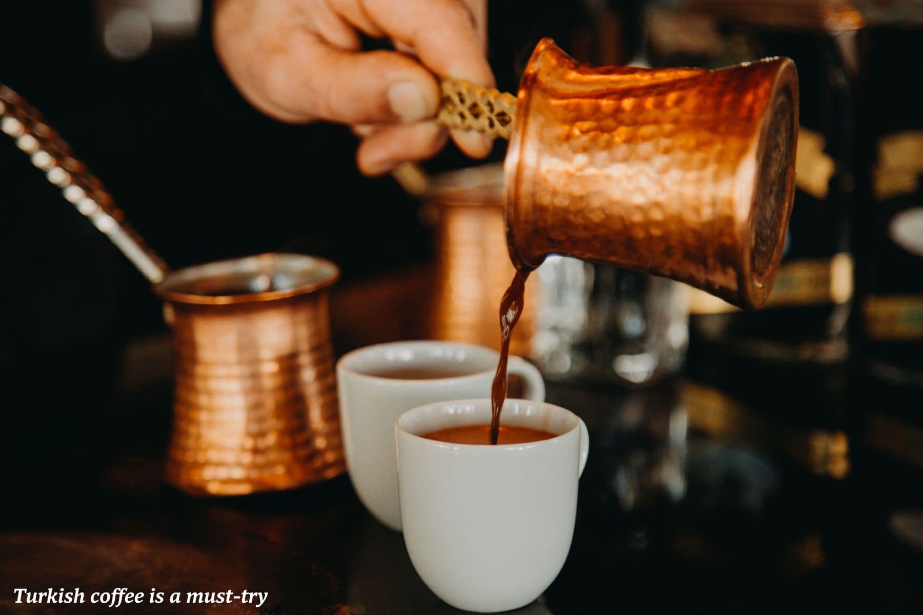 Man pouring small cups of Turkish coffee - coast of Turkey 